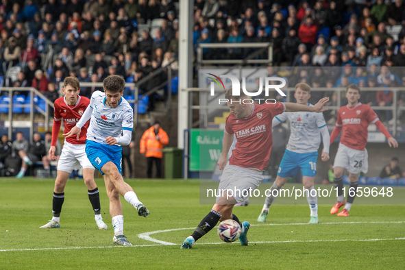 Kian Spence of Barrow shoots at goal past Jamie Stott of Morecambe during the Sky Bet League 2 match between Barrow and Morecambe at Holker...