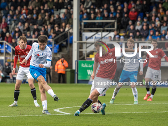 Kian Spence of Barrow shoots at goal past Jamie Stott of Morecambe during the Sky Bet League 2 match between Barrow and Morecambe at Holker...