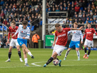 Kian Spence of Barrow shoots at goal past Jamie Stott of Morecambe during the Sky Bet League 2 match between Barrow and Morecambe at Holker...