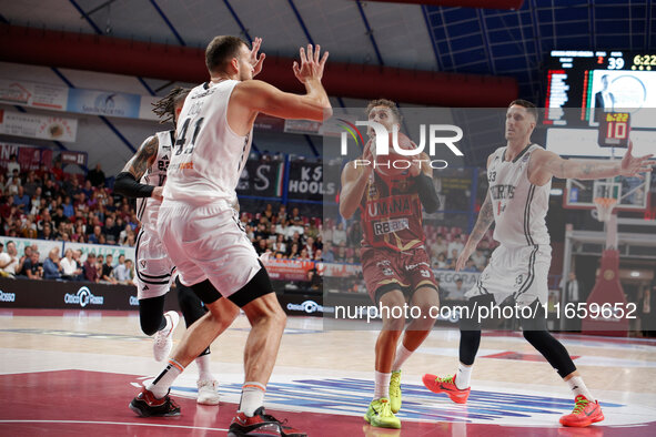 Umana Reyer's Davide Moretti competes against Virtus Bologna's Achille Polonara and Virtus Bologna's Ante Zizic during the Italian LBA baske...