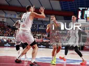 Umana Reyer's Davide Moretti competes against Virtus Bologna's Achille Polonara and Virtus Bologna's Ante Zizic during the Italian LBA baske...