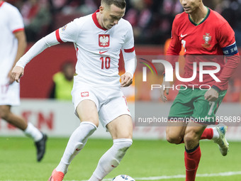 Piotr Zielinski , Cristiano Ronaldo  during UEFA Nations League match Poland vs Portugal in Warsaw Poland on 12 October 2024. (