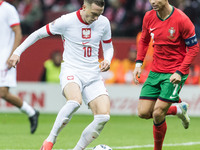 Piotr Zielinski , Cristiano Ronaldo  during UEFA Nations League match Poland vs Portugal in Warsaw Poland on 12 October 2024. (