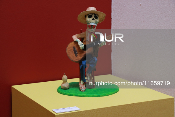 A skull made of cardboard, playing a guitar, is at the exhibition ''The Other Life in Tamoanchan'' at the National Museum of Popular Culture...