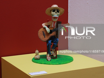 A skull made of cardboard, playing a guitar, is at the exhibition ''The Other Life in Tamoanchan'' at the National Museum of Popular Culture...