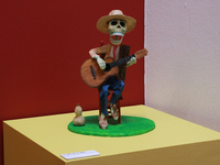 A skull made of cardboard, playing a guitar, is at the exhibition ''The Other Life in Tamoanchan'' at the National Museum of Popular Culture...