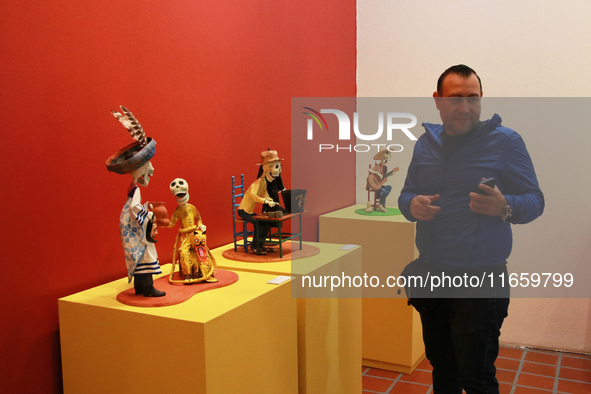 A man attends the exhibition ''The Other Life in Tamoanchan'' at the National Museum of Popular Cultures in Mexico City, Mexico, on October...