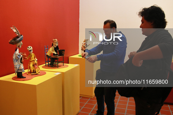 People look at the exhibition ''The Other Life in Tamoanchan'' at the National Museum of Popular Cultures in Mexico City, Mexico, on October...