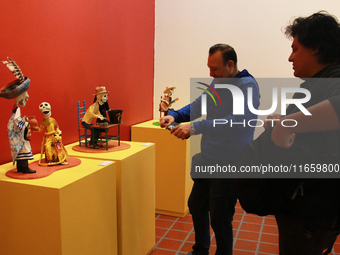 People look at the exhibition ''The Other Life in Tamoanchan'' at the National Museum of Popular Cultures in Mexico City, Mexico, on October...