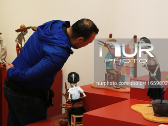 A man looks at the exhibition ''The Other Life in Tamoanchan'' at the National Museum of Popular Cultures in Mexico City, Mexico, on October...