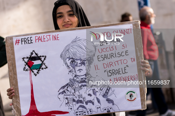 Members of the Palestinian student movement in Italy participate in a demonstration in the center of Rome to show their support for the Pale...