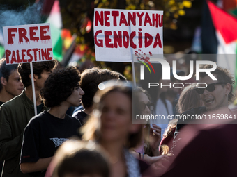 Members of the Palestinian student movement in Italy participate in a demonstration in the center of Rome to show their support for the Pale...