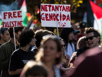 Members of the Palestinian student movement in Italy participate in a demonstration in the center of Rome to show their support for the Pale...