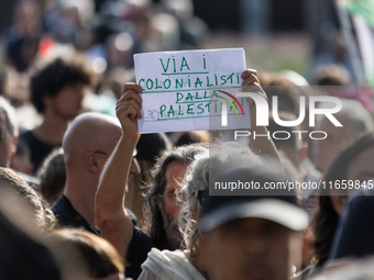 Members of the Palestinian student movement in Italy participate in a demonstration in the center of Rome to show their support for the Pale...