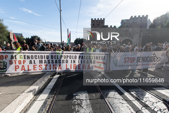 Members of the Palestinian student movement in Italy participate in a demonstration in the center of Rome to show their support for the Pale...