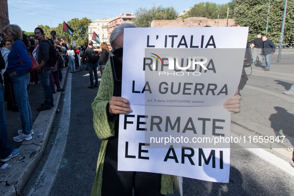 Members of the Palestinian student movement in Italy participate in a demonstration in the center of Rome to show their support for the Pale...