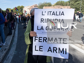 Members of the Palestinian student movement in Italy participate in a demonstration in the center of Rome to show their support for the Pale...