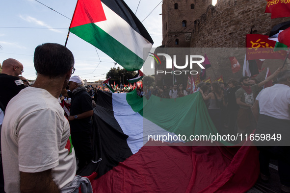 Members of the Palestinian student movement in Italy participate in a demonstration in the center of Rome to show their support for the Pale...