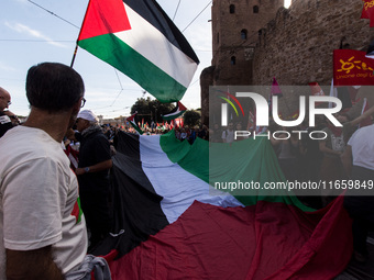 Members of the Palestinian student movement in Italy participate in a demonstration in the center of Rome to show their support for the Pale...