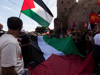 Members of the Palestinian student movement in Italy participate in a demonstration in the center of Rome to show their support for the Pale...