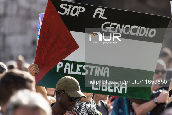 Members of the Palestinian student movement in Italy participate in a demonstration in the center of Rome to show their support for the Pale...