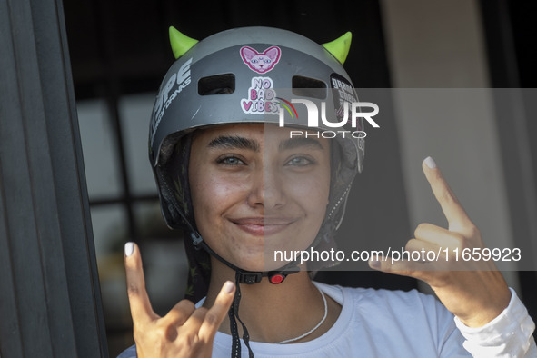 An Iranian woman reacts while waiting to perform in a freestyle bicycle competition at the Navid BMX Bike Park in southern Tehran, Iran, on...