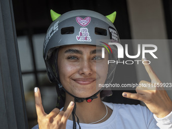 An Iranian woman reacts while waiting to perform in a freestyle bicycle competition at the Navid BMX Bike Park in southern Tehran, Iran, on...