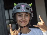 An Iranian woman reacts while waiting to perform in a freestyle bicycle competition at the Navid BMX Bike Park in southern Tehran, Iran, on...