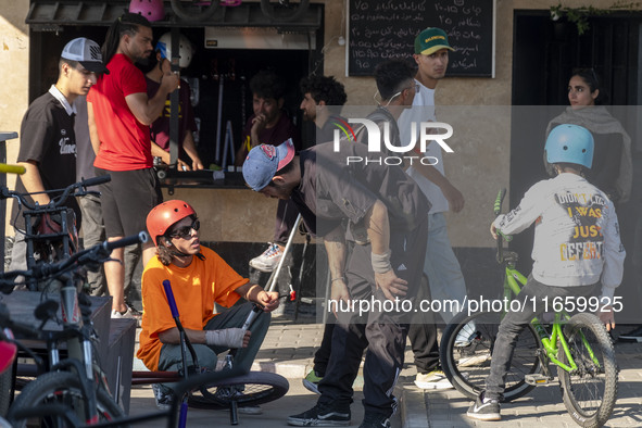 Iranian participants wait to perform in a freestyle bicycle competition while checking their BMX bikes at the Navid BMX Bike Park in souther...