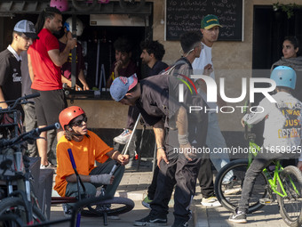 Iranian participants wait to perform in a freestyle bicycle competition while checking their BMX bikes at the Navid BMX Bike Park in souther...