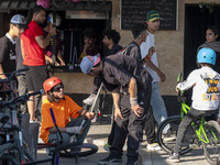 Iranian participants wait to perform in a freestyle bicycle competition while checking their BMX bikes at the Navid BMX Bike Park in souther...