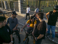 Iranian youths sit together on their BMX bikes while they wait to perform in a freestyle bicycle competition at the Navid BMX Bike Park in s...