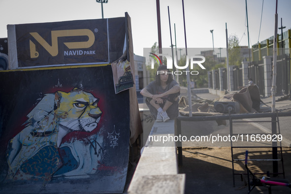 An Iranian participant waits to perform in a freestyle bicycle competition at the Navid BMX Bike Park in southern Tehran, Iran, on October 1...