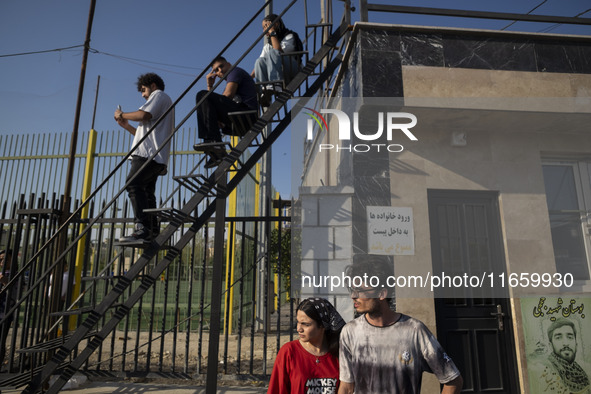 Iranian youths watch a freestyle bicycle competition at the Navid BMX Bike Park in southern Tehran, Iran, on October 11, 2024. 