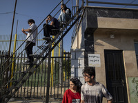 Iranian youths watch a freestyle bicycle competition at the Navid BMX Bike Park in southern Tehran, Iran, on October 11, 2024. (