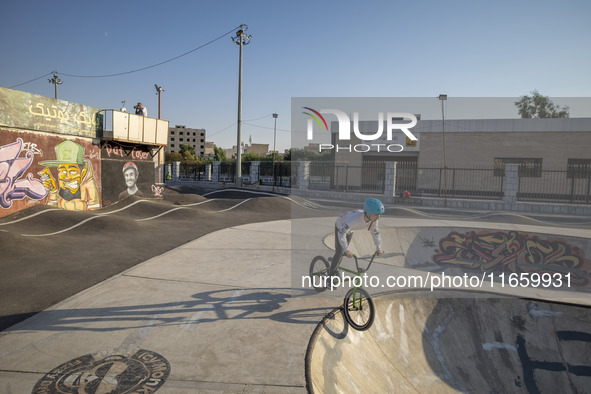 An Iranian participant warms up before taking part in a freestyle bicycle competition at the Navid BMX Bike Park in southern Tehran, Iran, o...