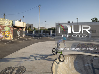 An Iranian participant warms up before taking part in a freestyle bicycle competition at the Navid BMX Bike Park in southern Tehran, Iran, o...