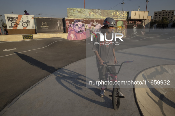 An Iranian participant sits on his BMX bike before taking part in a freestyle bicycle competition at the Navid BMX Bike Park in southern Teh...