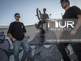 Iranian participants pose for a photograph before taking part in a freestyle bicycle competition at the Navid BMX Bike Park in southern Tehr...