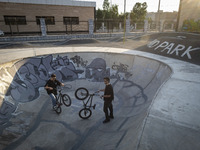 Two Iranian participants warm up before taking part in a freestyle bicycle competition at the Navid BMX Bike Park in southern Tehran, Iran,...