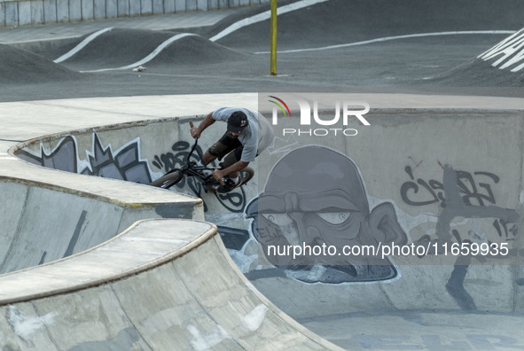 An Iranian participant warms up before taking part in a freestyle bicycle competition at the Navid BMX Bike Park in southern Tehran, Iran, o...