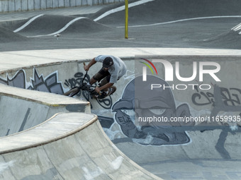 An Iranian participant warms up before taking part in a freestyle bicycle competition at the Navid BMX Bike Park in southern Tehran, Iran, o...