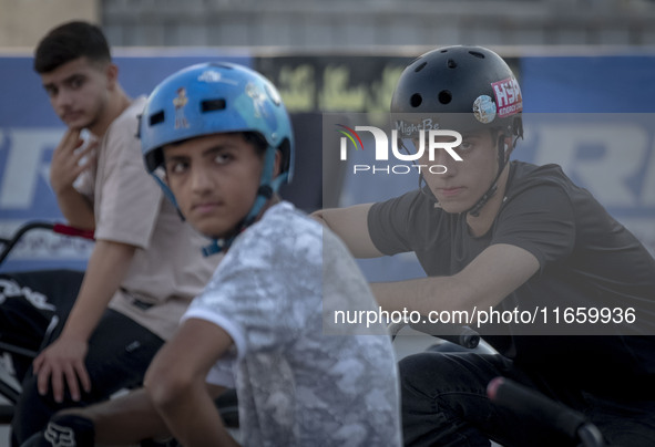 Iranian participants wait to take part in a freestyle bicycle competition at the Navid BMX Bike Park in southern Tehran, Iran, on October 11...