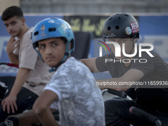 Iranian participants wait to take part in a freestyle bicycle competition at the Navid BMX Bike Park in southern Tehran, Iran, on October 11...