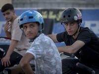 Iranian participants wait to take part in a freestyle bicycle competition at the Navid BMX Bike Park in southern Tehran, Iran, on October 11...