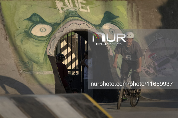 An Iranian participant rides a BMX bike in a freestyle bicycle competition at the Navid BMX Bike Park in southern Tehran, Iran, on October 1...