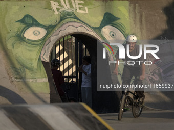 An Iranian participant rides a BMX bike in a freestyle bicycle competition at the Navid BMX Bike Park in southern Tehran, Iran, on October 1...