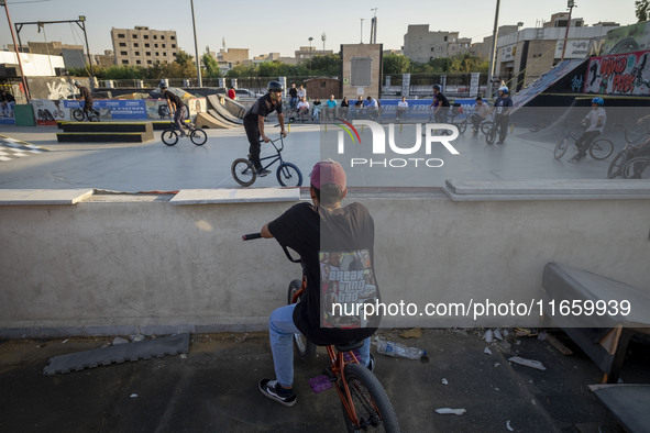 Iranian youths warm up before participating in a freestyle bicycle competition at the Navid BMX Bike Park in southern Tehran, Iran, on Octob...