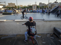 Iranian youths warm up before participating in a freestyle bicycle competition at the Navid BMX Bike Park in southern Tehran, Iran, on Octob...