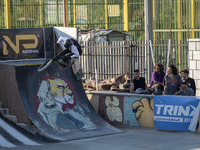 Young Iranian men watch a young woman perform in a freestyle bicycle competition at the Navid BMX Bike Park in southern Tehran, Iran, on Oct...